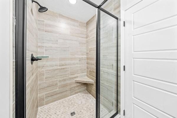 bathroom featuring a shower with shower door