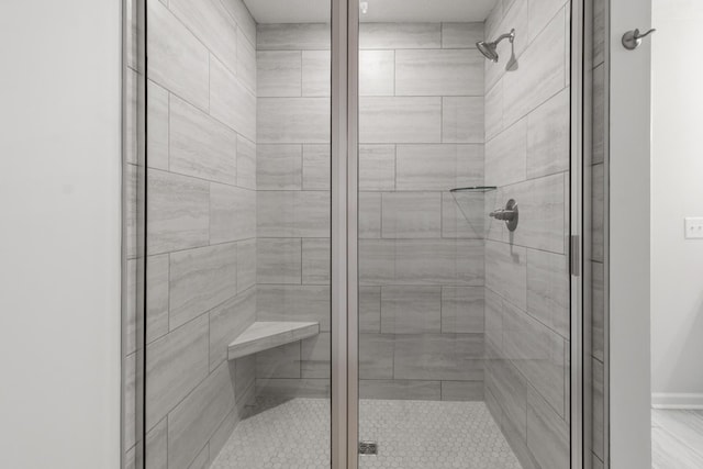 bathroom featuring a shower with door