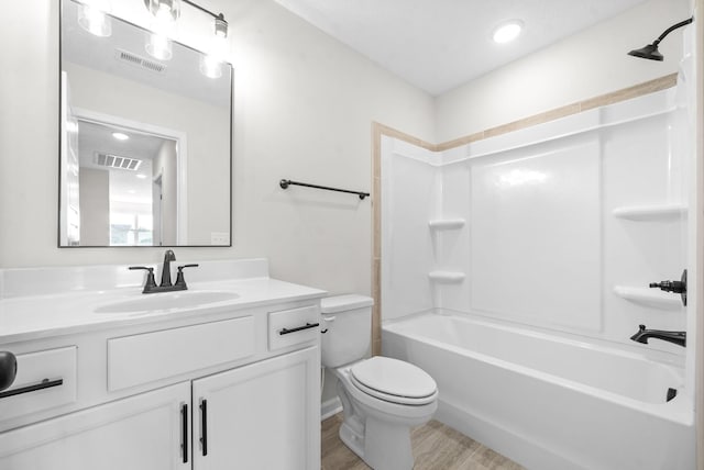 full bathroom with wood-type flooring, toilet, shower / bath combination, and vanity