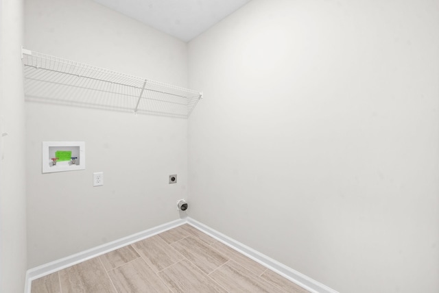 washroom with electric dryer hookup, hookup for a washing machine, and light hardwood / wood-style flooring