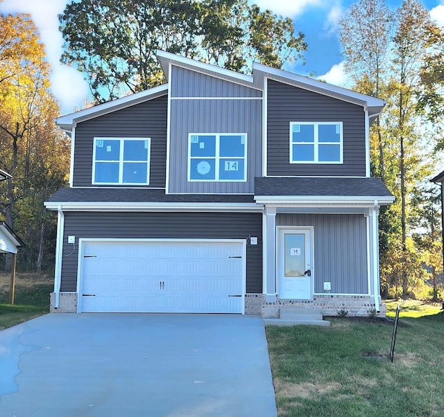 view of front of property with a garage and a front lawn