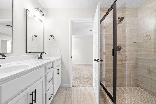 bathroom with walk in shower and vanity