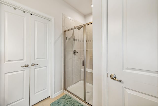 bathroom featuring tile patterned flooring and a shower with door