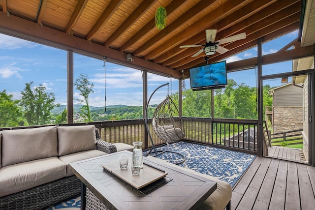 sunroom featuring wood ceiling, ceiling fan, and lofted ceiling with beams