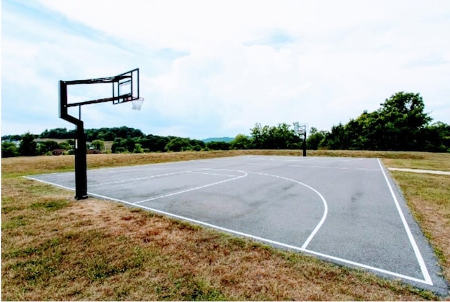 view of basketball court featuring a lawn