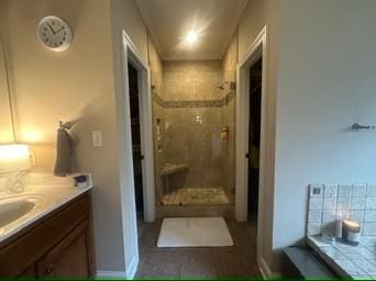 bathroom with walk in shower and vanity