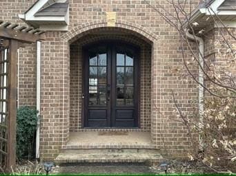 entrance to property featuring french doors