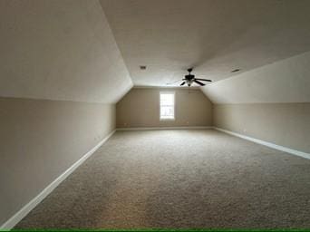 additional living space with lofted ceiling, carpet floors, and ceiling fan