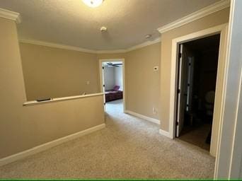 corridor featuring light colored carpet and ornamental molding