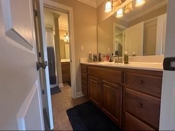 bathroom with vanity, tile patterned flooring, and ornamental molding