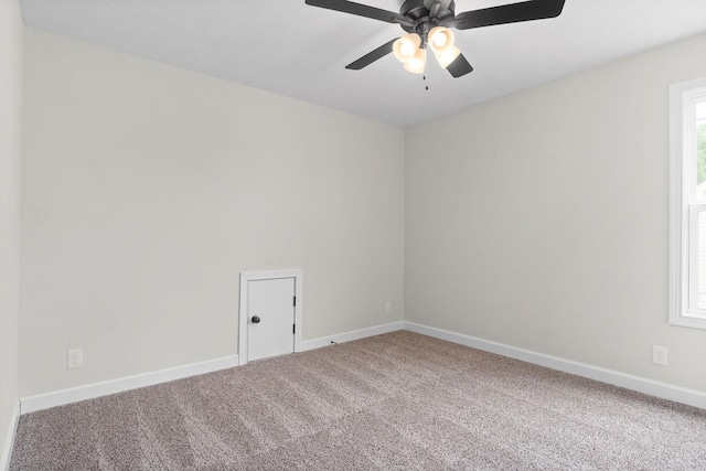 carpeted spare room with ceiling fan