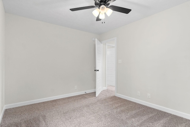 spare room with light colored carpet and ceiling fan