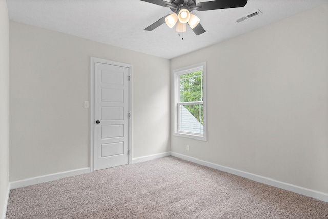 spare room with ceiling fan, carpet floors, and a textured ceiling