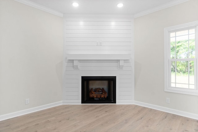 interior details featuring crown molding, a fireplace, and hardwood / wood-style floors