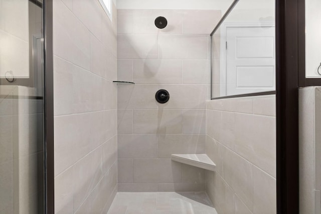 bathroom with a tile shower