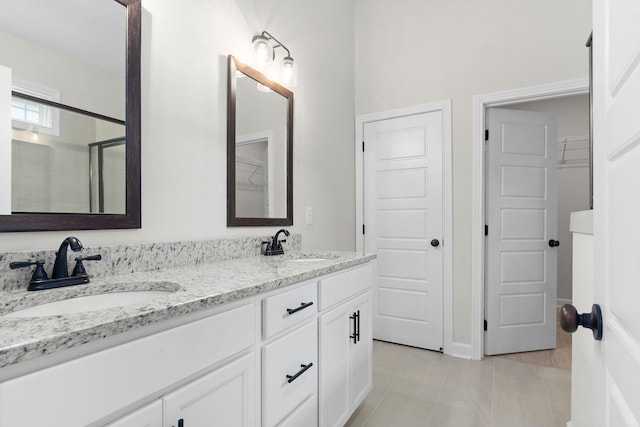 bathroom with vanity, tile patterned floors, and a shower with door