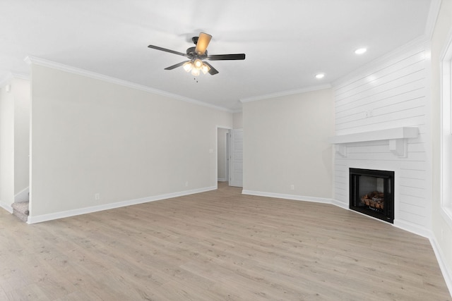 unfurnished living room featuring crown molding, ceiling fan, a fireplace, and light hardwood / wood-style flooring