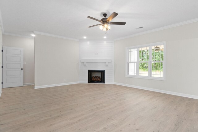 unfurnished living room with crown molding, ceiling fan, a fireplace, and light hardwood / wood-style flooring