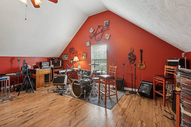 office area featuring ceiling fan, lofted ceiling, light hardwood / wood-style floors, and a textured ceiling