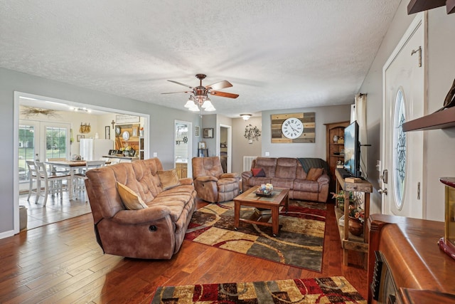 living room with hardwood / wood-style flooring, a textured ceiling, and french doors