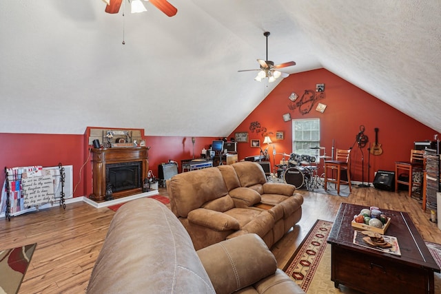 living room featuring lofted ceiling, hardwood / wood-style floors, a textured ceiling, and ceiling fan