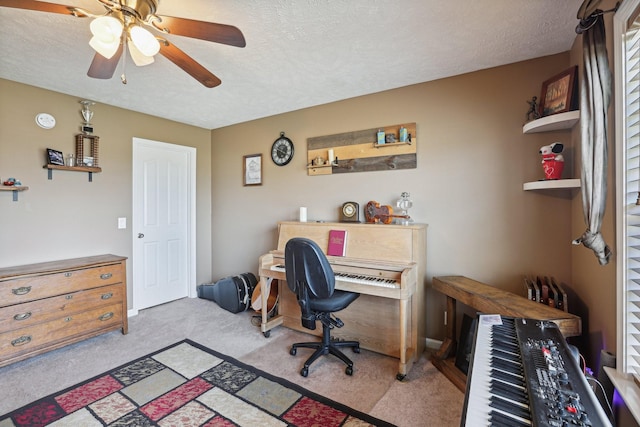 carpeted office space with ceiling fan and a textured ceiling