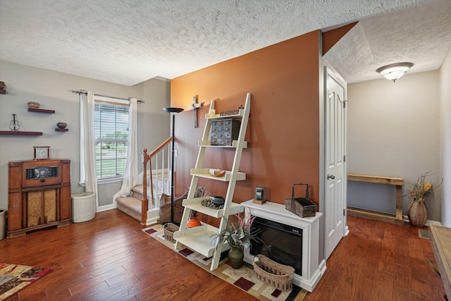 interior space with dark wood-type flooring and a textured ceiling