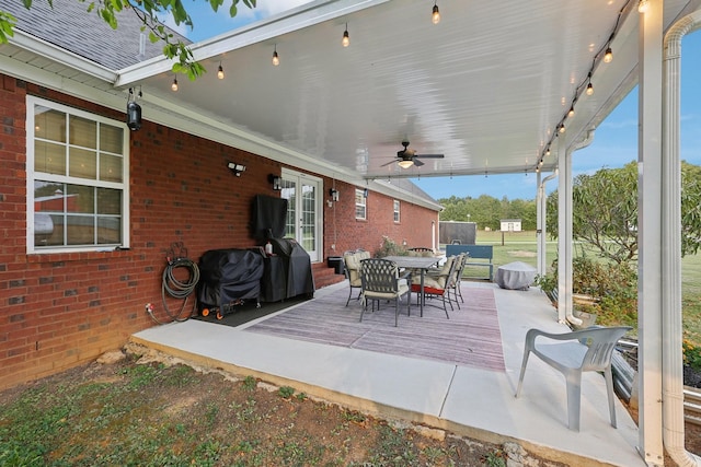 view of patio / terrace featuring a wooden deck, ceiling fan, and grilling area