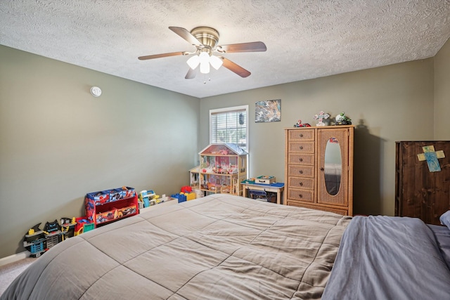 carpeted bedroom with ceiling fan and a textured ceiling