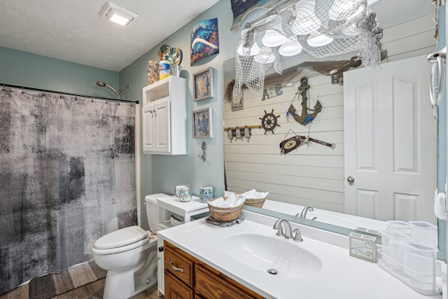 bathroom featuring wooden walls, vanity, toilet, and curtained shower