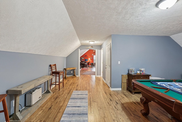 recreation room featuring lofted ceiling, a textured ceiling, light wood-type flooring, and billiards