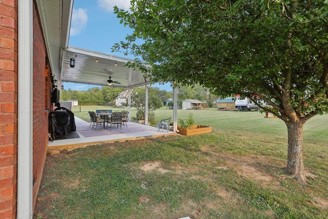 view of yard featuring ceiling fan and a patio area