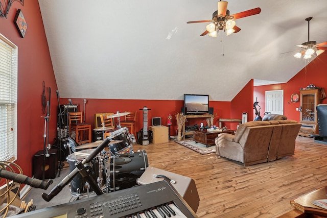 living room with lofted ceiling, ceiling fan, and light hardwood / wood-style flooring