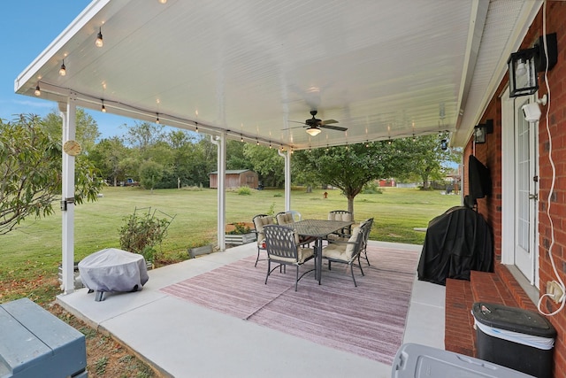 view of patio featuring ceiling fan and a storage shed