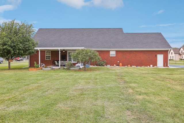 back of house featuring a patio and a lawn