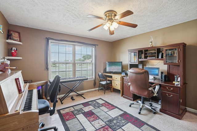 carpeted office with ceiling fan and a textured ceiling