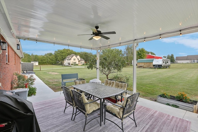 wooden deck with a grill, ceiling fan, and a lawn