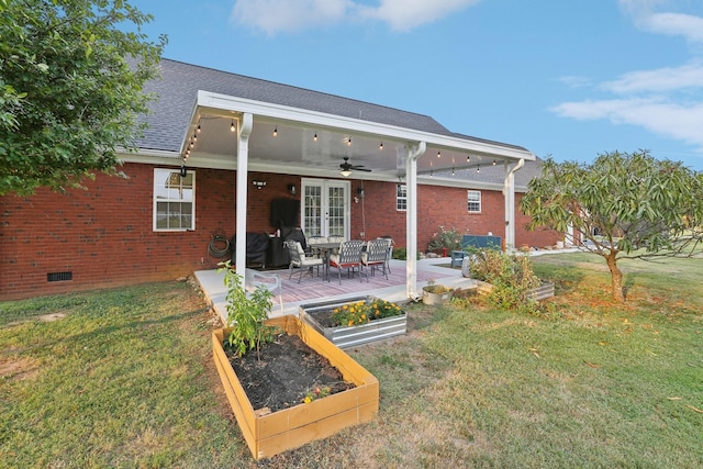 back of property with ceiling fan, a patio area, and a lawn