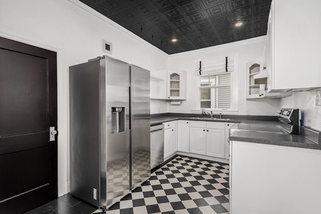 kitchen featuring white cabinetry, sink, ornamental molding, and stainless steel appliances