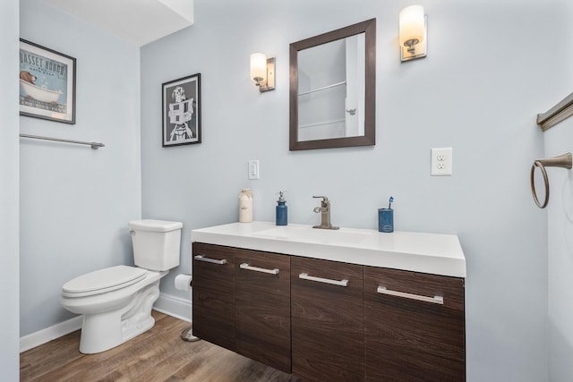 bathroom with vanity, wood-type flooring, and toilet