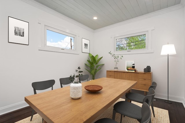 dining space with dark hardwood / wood-style flooring, crown molding, and plenty of natural light