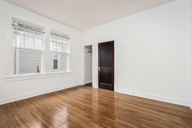 empty room with hardwood / wood-style flooring