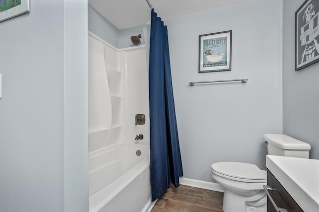 full bathroom with hardwood / wood-style flooring, vanity, toilet, and shower / bath combo with shower curtain