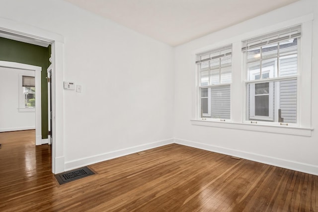 spare room with dark hardwood / wood-style flooring