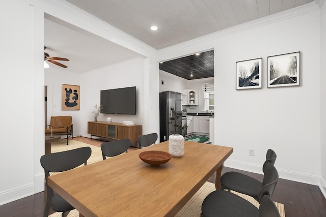 dining room featuring dark hardwood / wood-style flooring, ornamental molding, and ceiling fan