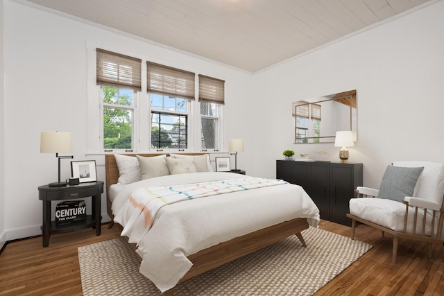 bedroom featuring hardwood / wood-style floors and crown molding