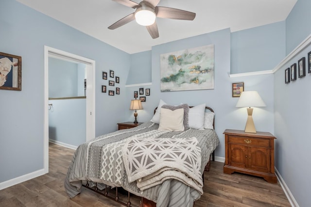 bedroom with dark hardwood / wood-style flooring and ceiling fan