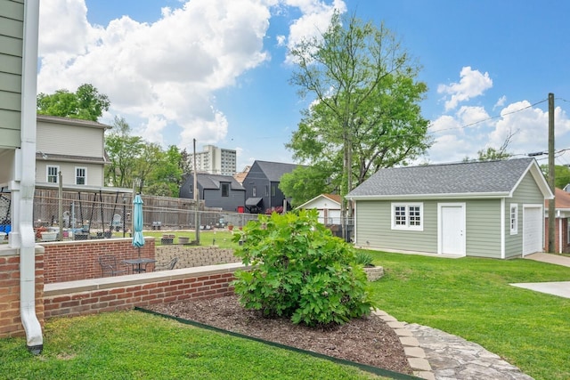 view of yard with a garage, an outbuilding, and an outdoor fire pit