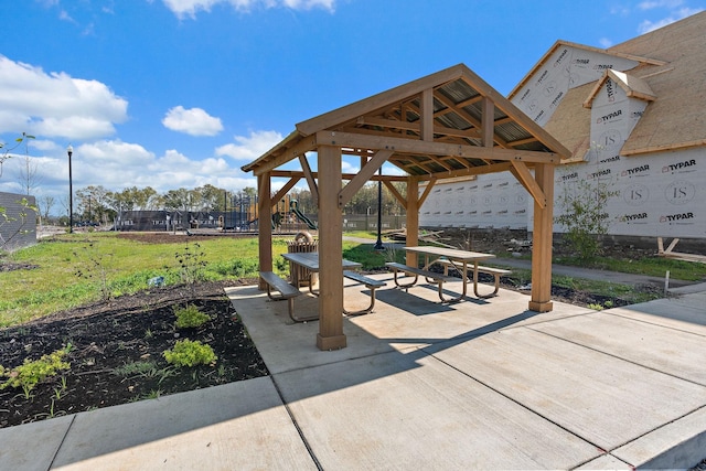 view of home's community featuring a playground, a gazebo, and a patio area