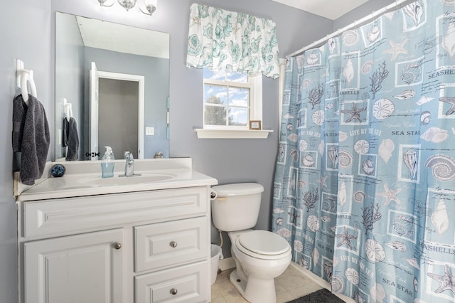 bathroom featuring tile patterned flooring, vanity, and toilet